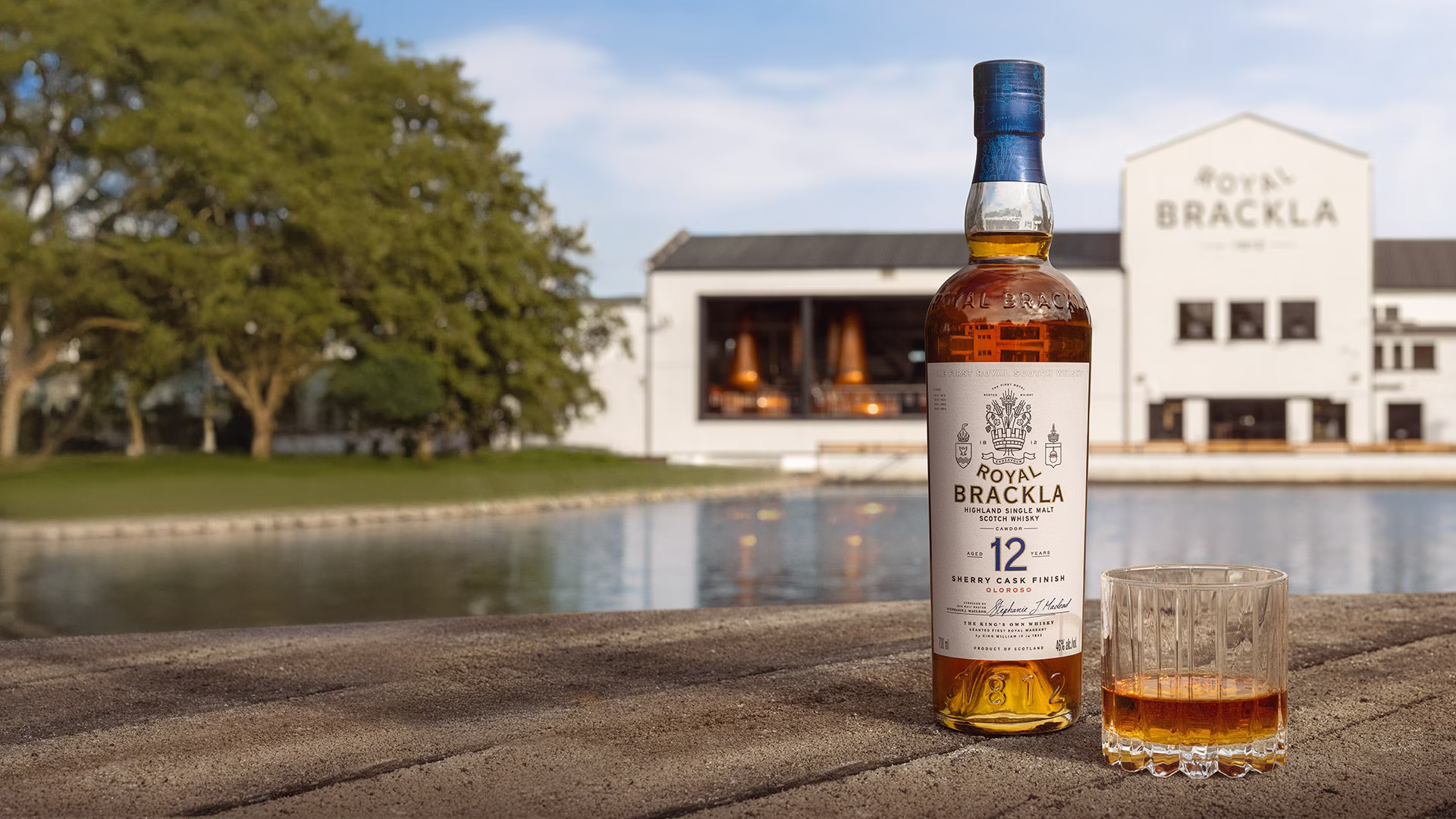 Bottle of Royal Brackla 12-year-old Highland Single Malt Scotch Whisky with glass of amber whisky.